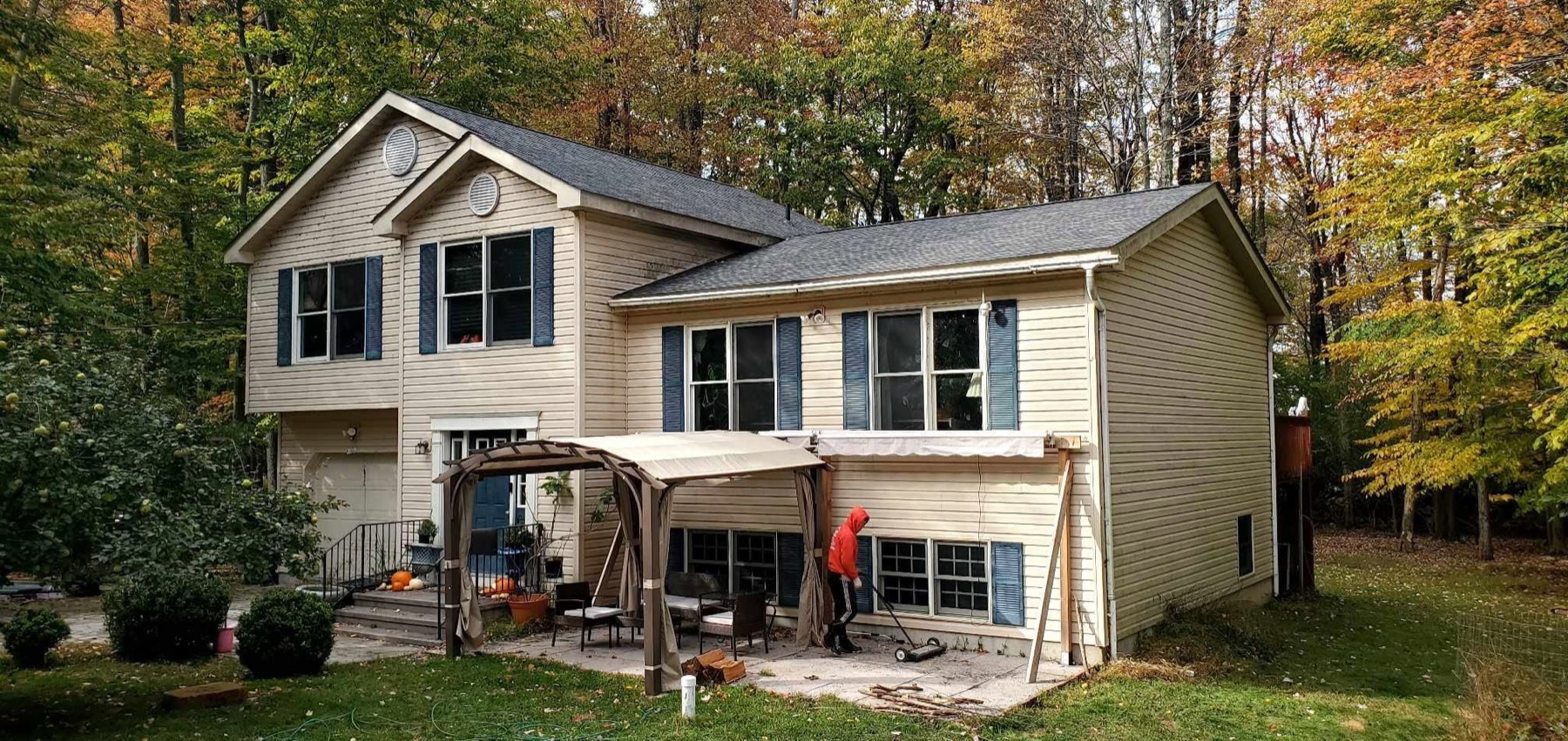 The same split-level home after a one-day Rail Roofing Group replacement, with a new architectural shingle roof